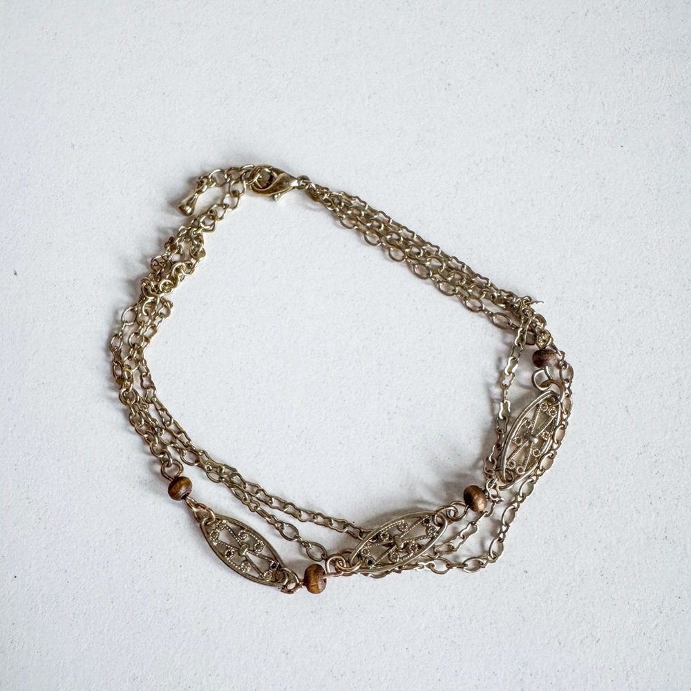 Gold multi strand ankle bracelet with adjustable size clasp closure